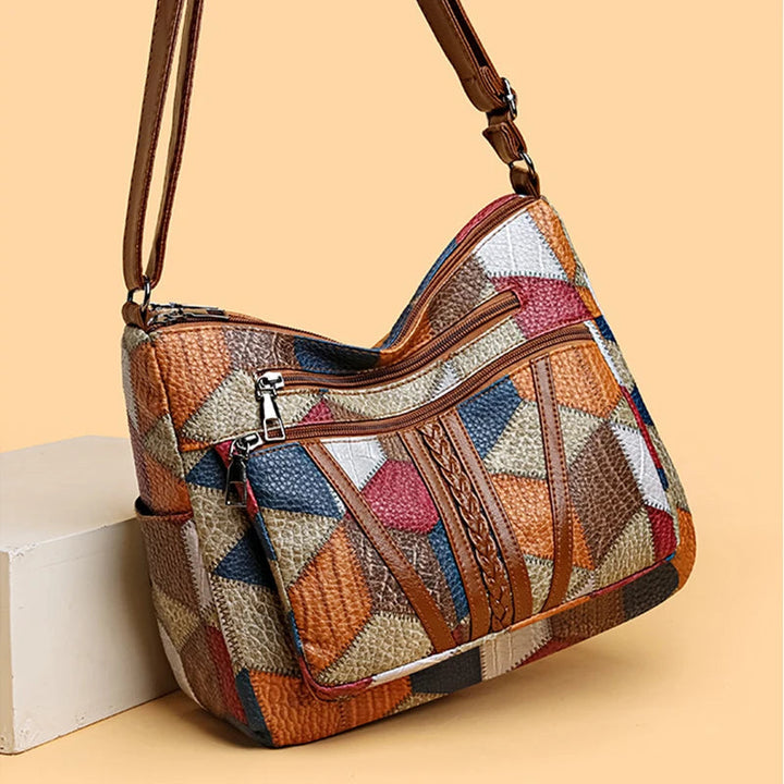 Lauranique - Borsa a tracolla in patchwork con finitura soft touch