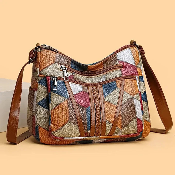 Lauranique - Borsa a tracolla in patchwork con finitura soft touch