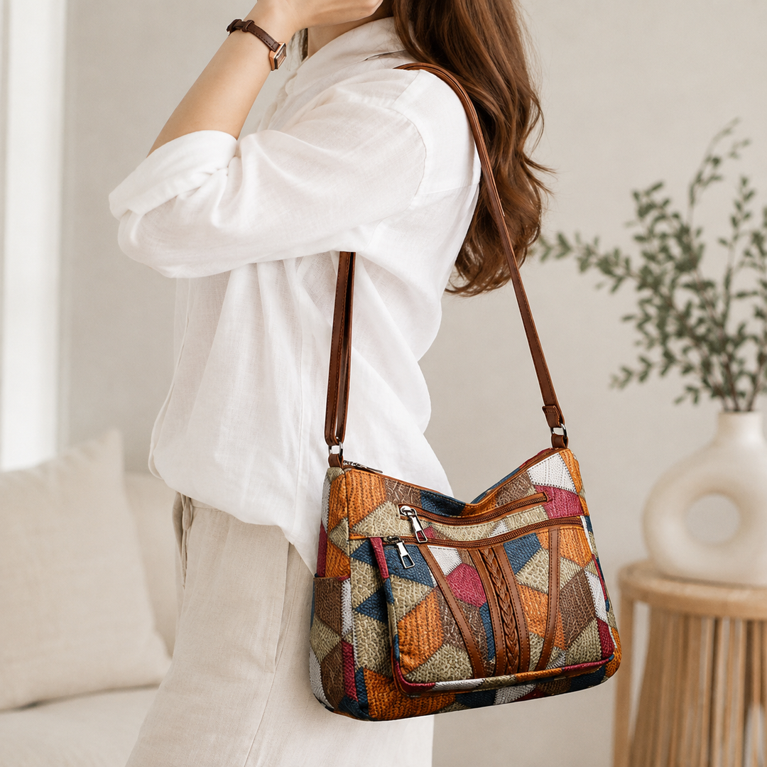 Lauranique - Borsa a tracolla in patchwork con finitura soft touch